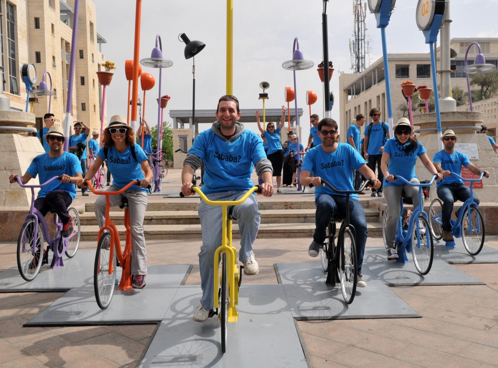 Samuel Green, a licensed Israeli tour guide, with a group on bikes, all in matching shirts.