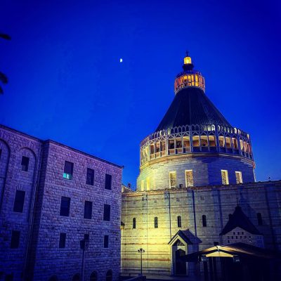 The Basilica of the Annunciation lit up at dusk in Nazareth