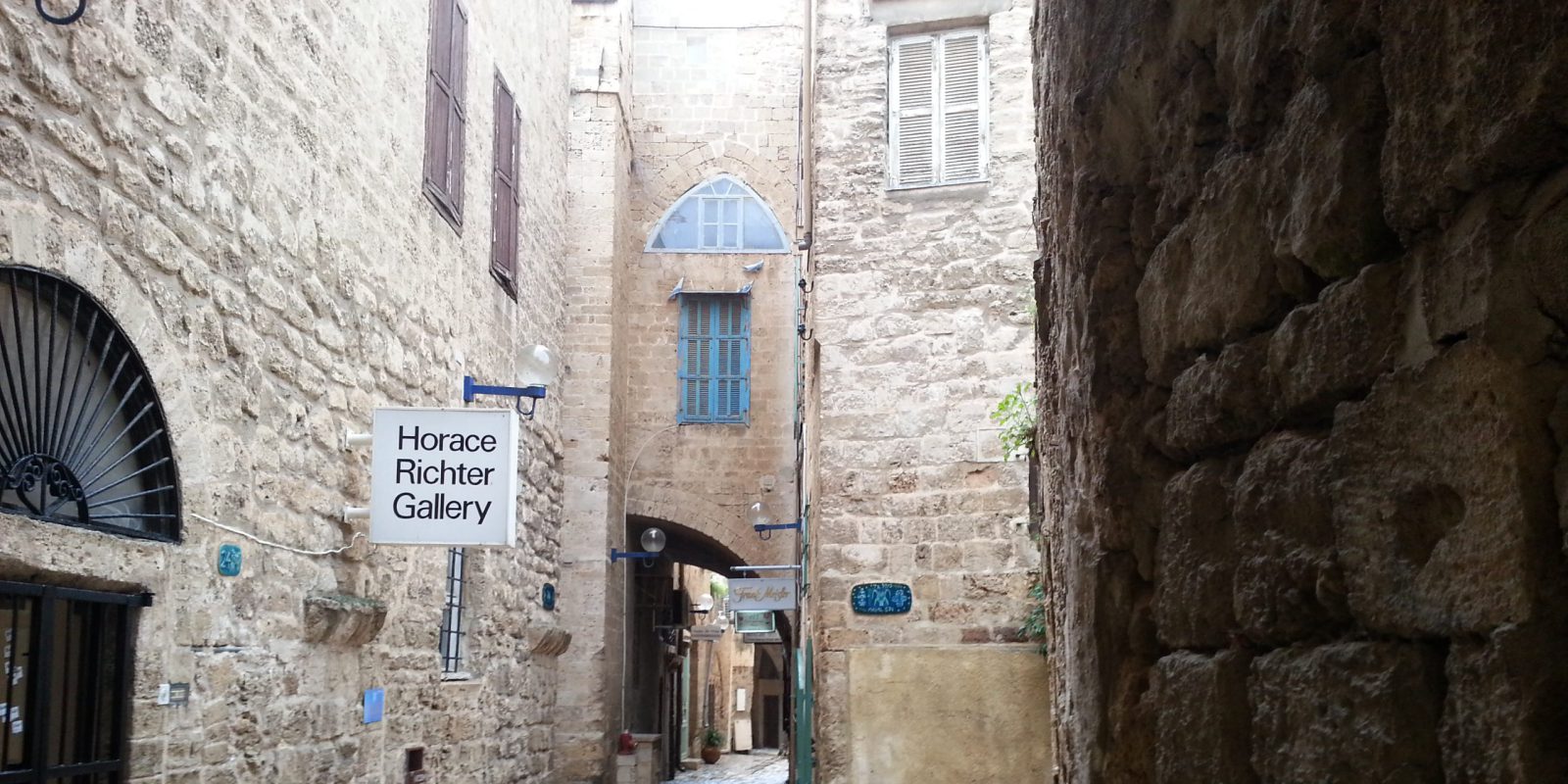 A stone alleyway in Old Jaffa, with the Horace Richter Gallery sign