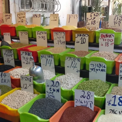Stalls and shoppers along a lane of the Carmel Market in Tel Aviv