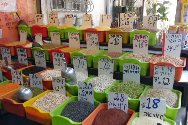 Stalls and shoppers along a lane of the Carmel Market in Tel Aviv