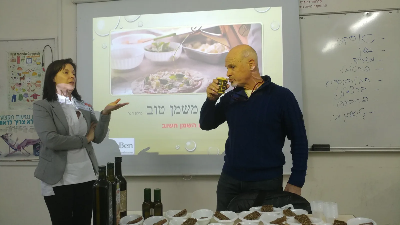 A live olive oil tasting demonstration at the culinary tourism course, the instructor tasting oil from a small cup